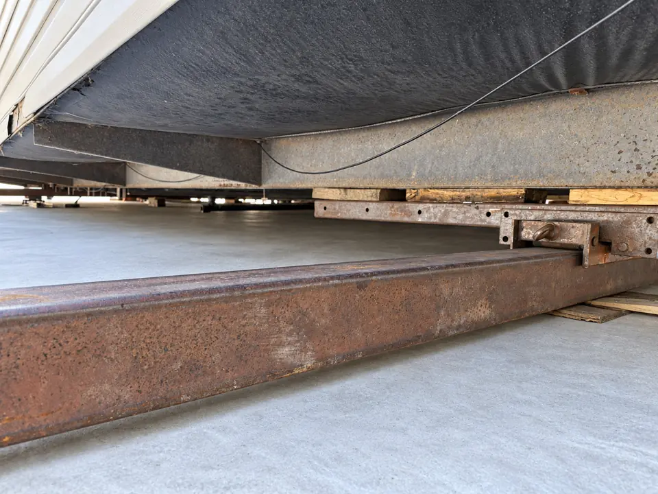 Close view of steel tracks beneath a manufactured home